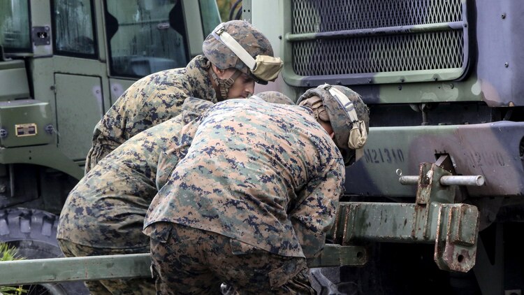 Marine students in the 8th Engineer Support Battalion Bridge Master’s Course rig a bridge piece to a seven-ton vehicle during a field exercise at Marine Corps Base Camp Lejeune, N.C., Nov. 4, 2015. The course teaches Marines to lead the bridge building process, and is hosting Marines from 9th Engineer Support Battalion, 3rd Marine Logistics Group, based in Camp Hansen, Okinawa. Marines used the seven-ton vehicle to push or pull the entire bridge as needed.