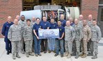 Connecticut Air National Guard's 103rd Maintenance Squadron and members of the senior enlisted advisory council commemorate the squadron's 100th overhaul of the TF34, or turbofan, engine at the centralized repair facility at Bradley Air National Guard Base, Conn., Oct. 10, 2011. Air Force Chief Master Sgt. Denise Jelinski-Hall, senior enlisted advisor to the chief of the National Guard Bureau (front row, second from left) attended the commemoration event.