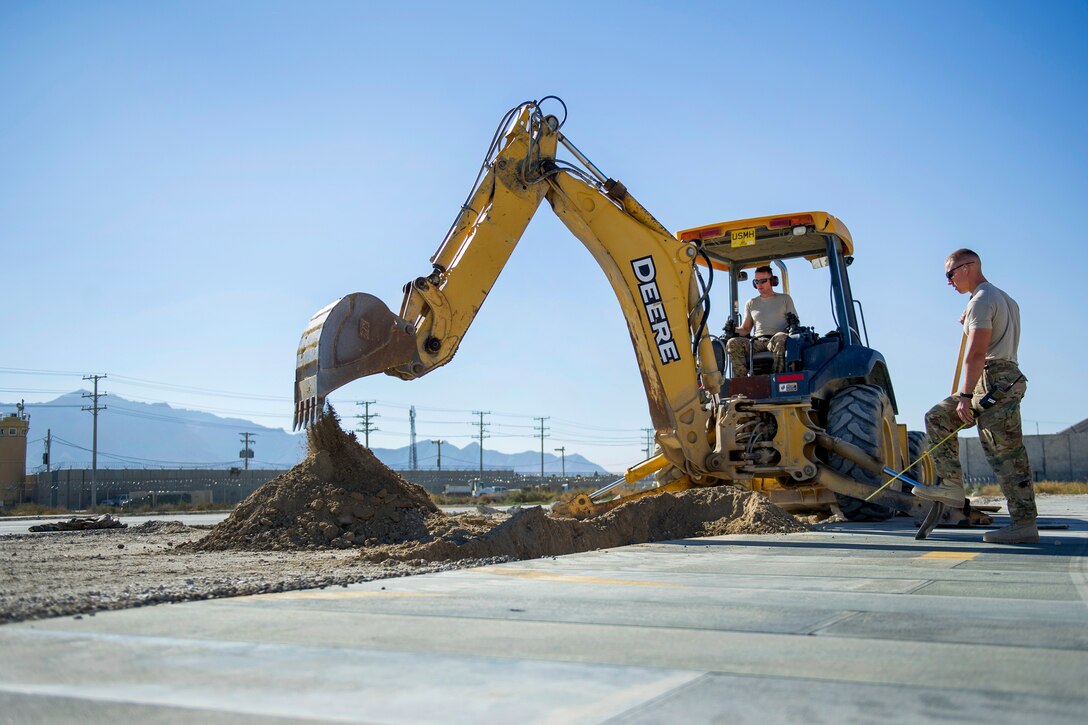 U.S. Air Force Tech. Sgt. David Blankenship and U.S. Air Force Airman 1st Class Patrick Chuba work on a construction project at
Bagram Airfield, Afghanistan, Nov. 4, 2015. Blankenship and Chuba are pavements and equipment technicians assigned to the 455th Expeditionary Civil Engineer Squadron. The unit prepared an area for cement to support a maintenance structure slated for construction in the next few months. U.S. Air Force photo by Tech. Sgt. Robert Cloys