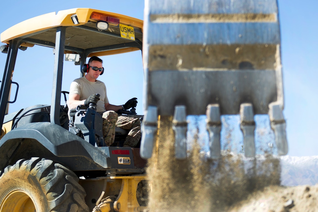 U.S. Air Force Tech. Sgt. David Blankenship operates a backhoe during a construction project at Bagram Airfield, Afghanistan, Nov. 4, 2015. Blankenship is a pavements and equipment technician assigned to the 455th Expeditionary Civil Engineer Squadron. U.S. Air Force photo by Tech. Sgt. Robert Cloys