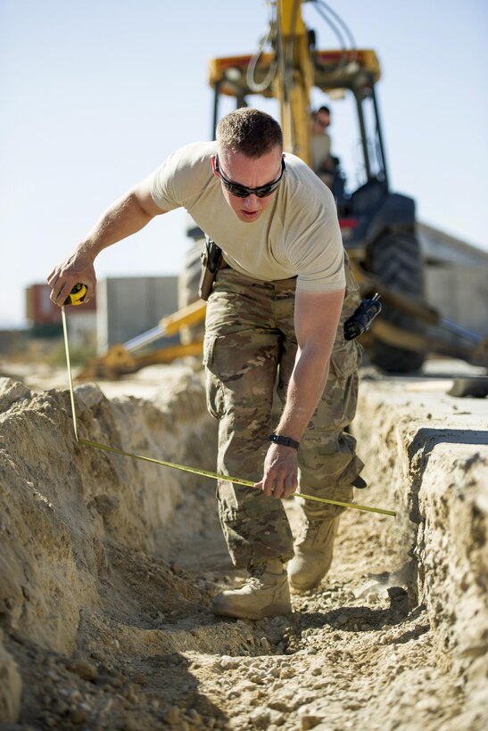 U.S. Air Force Airman 1st Class Patrick Chuba measures a construction site at Bagram Airfield, Afghanistan, Nov. 4, 2015. Chuba is a pavements and equipment technician assigned to the 455th Expeditionary Civil Engineer Squadron. U.S. Air Force photo by Tech. Sgt. Robert Cloys