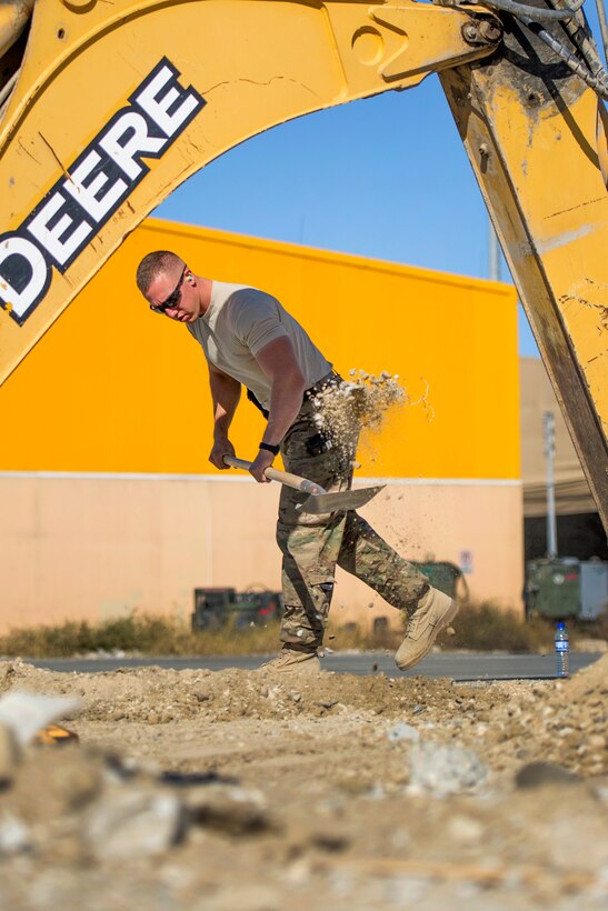 U.S. Air Force Airman 1st Class Patrick Chuba shovels excess dirt at a construction site at Bagram Airfield, Afghanistan, Nov. 4, 2015. Chuba is a pavements and equipment technician assigned to the 455th Expeditionary Civil Engineer Squadron. U.S. Air Force photo by Tech. Sgt. Robert Cloys