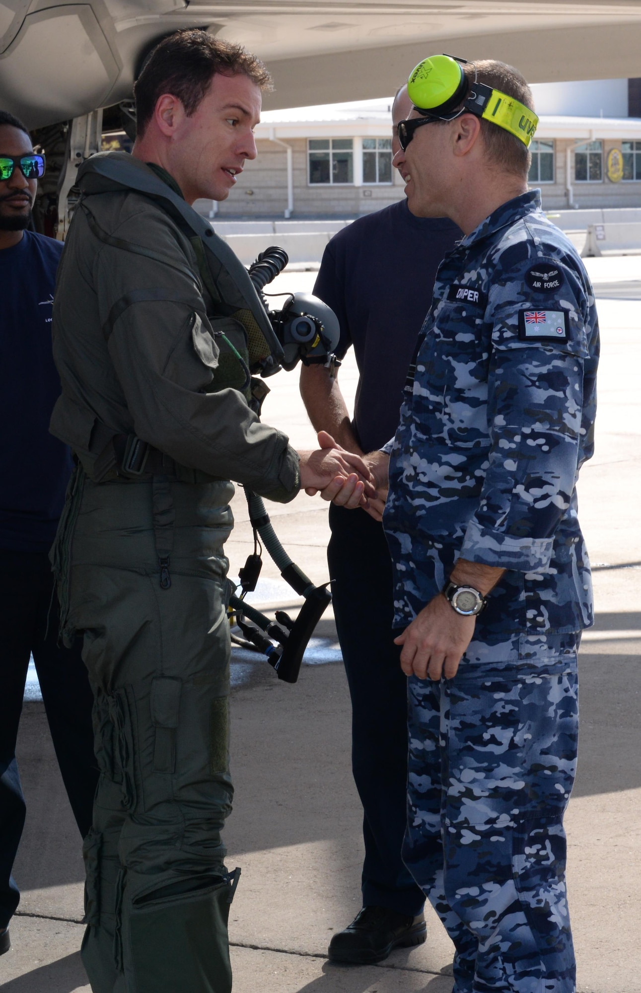 An Italian F-35 Lightning II pilot shakes the hand of Squadron Leader Nathan Draper, an Australian participant maintenance liaison officer, Nov. 5, 2015, at Luke Air Force Base, Ariz., after flying the first Italian F-35 training mission. (U.S. Air Force photo/Airman 1st Class Ridge Shan) 