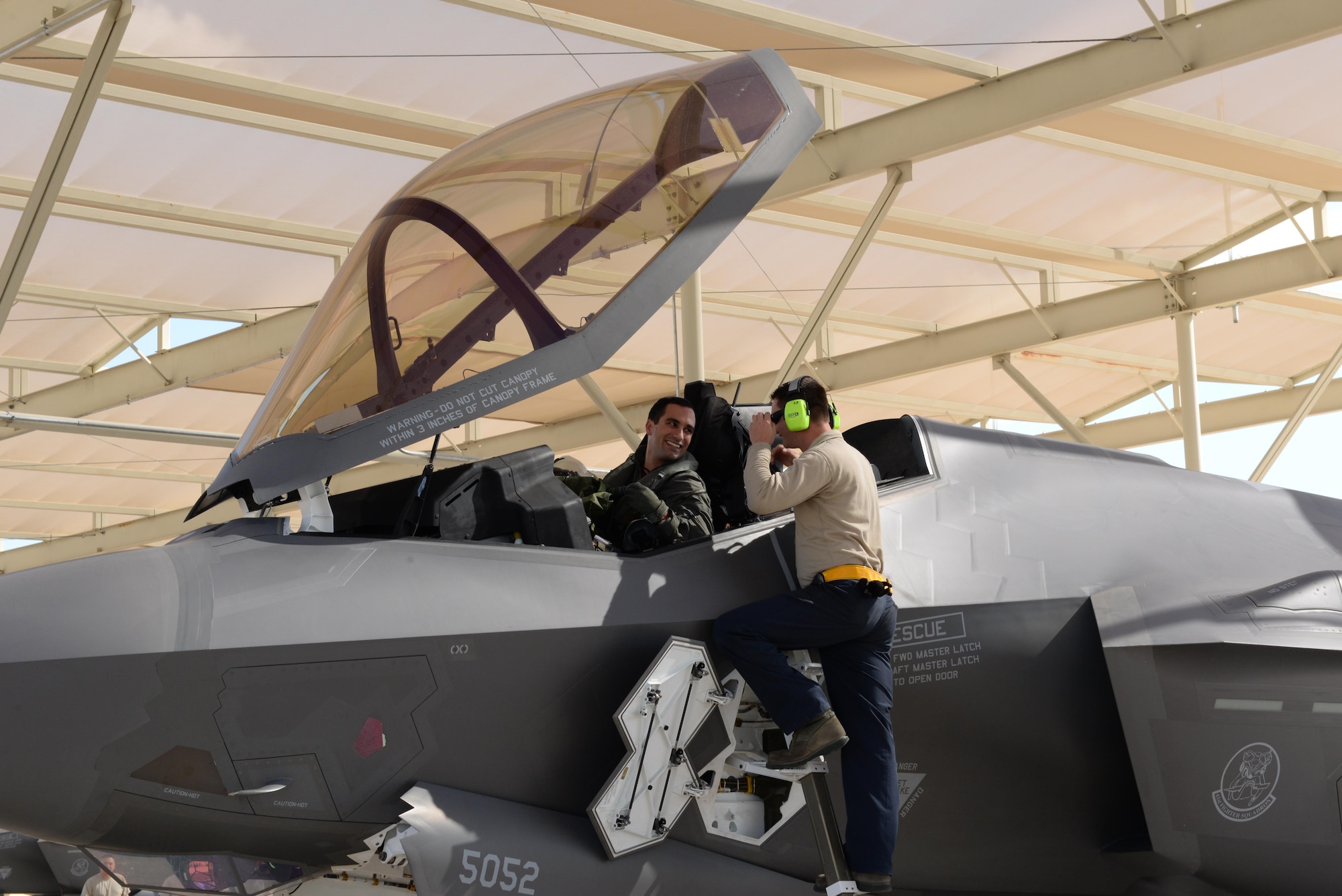 An Italian F-35 Lightning II pilot is met by a 61st Aircraft Maintenance Unit Airman Nov. 5, 2015, at Luke Air Force Base, Ariz., after the pilot flew the first Italian F-35 training mission. (U.S. Air Force photo/Airman 1st Class Ridge Shan)