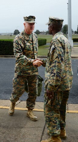 Maj. Gen. Charles L. Hudson, (left) commander, Marine Corps Installations Command, is met by Col. James C. Carroll III, commanding officer, Marine Corps Logistics Base Albany, in front of Building 3500 during Hudson’s visit, here, Nov. 4.