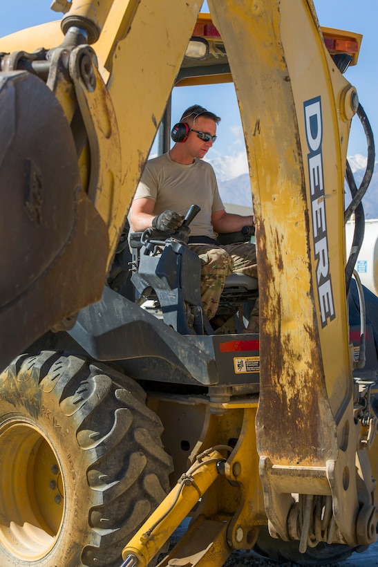 U.S. Air Force Tech. Sgt. David Blankenship operates a backhoe during a construction project at Bagram Airfield, Afghanistan, Nov. 4, 2015. Blankenship is a pavements and equipment technician assigned to the 455th Expeditionary Civil Engineer Squadron. U.S. Air Force photo by Tech. Sgt. Robert Cloys 