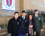 Army National Guard Pvt. Angel Chavez poses with his brother, Anthony Chavez (left), his sister, Julissa Corona and brother-in-law Army Staff Sgt. Todd Corona (right) following his high school graduation ceremony at the National Guard Patriot Academy, Nov. 4, 2011 at the Muscatatuck Urban Training Complex in Butlerville, Ind. Chavez became a U.S. citizen in October.