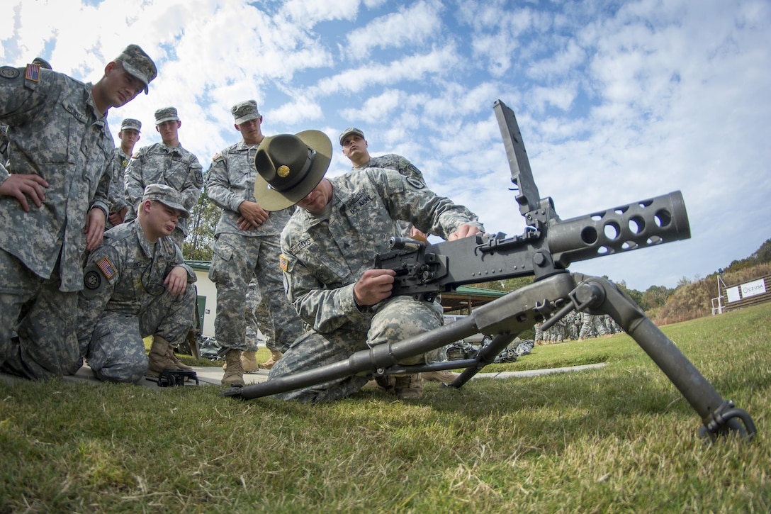 Army Sgt. Larry Davis, right, instructs a group of Clemson University Reserve Officer Training Corps cadets how to pull apart an M2 .50-caliber machine gun as part of a leadership exercise in Clemson, S.C., Oct. 24, 2015. Davis is an Army Reserve drill sergeant assigned to the 98th Training Division's Company D, 1st Battalion, 518th Infantry Regiment, 2nd Brigade Combat Team. U.S. Army photo by Sgt. Ken Scar