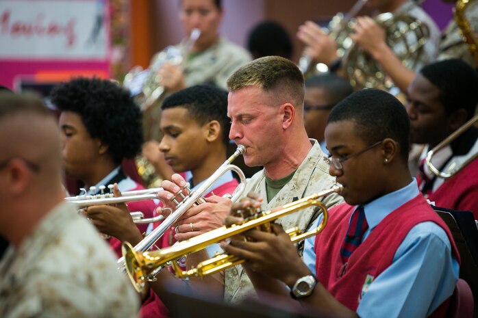 Sgt. Aaron Carpenter performs alongside students at the Cedar Bridge Academy in Bermuda. 2nd MAW band visited the school to share musical knowledge with the younger students, prior to their performance at the Bermuda 50th Regiment Tattoo, 22-24 October. The Bermuda Tattoo presented a world-class spectacle of music and military precision at the historic grounds of the Keep Yard, Royal Naval Dockyard. Performers from the United States, United Kingdom, Canada and the Caribbean joined the Royal Bermuda Regiment Band and Corps of Drums. (Courtesy Photo)

