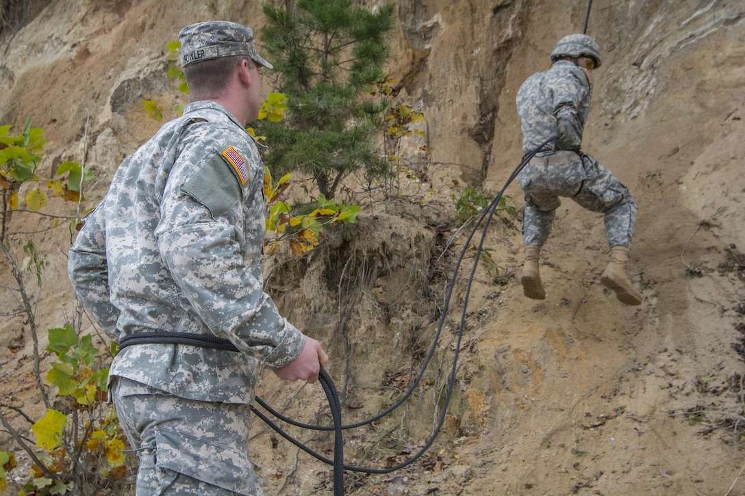 Army 1st Lt. Jeoffrey Fowler holds belay and instructs a Clemson University Reserve Officer Training Corps cadet as he rappels down a cliff on the shore of Lake Hartwell, S.C., Oct. 24, 2015. Fowler, a member of the Army Reserve, is assigned to the 98th Training Division's Company D, 1st Battalion, 518th Infantry Regiment, 2nd Brigade Combat Team. U.S. Army photo by Sgt. Ken Scar