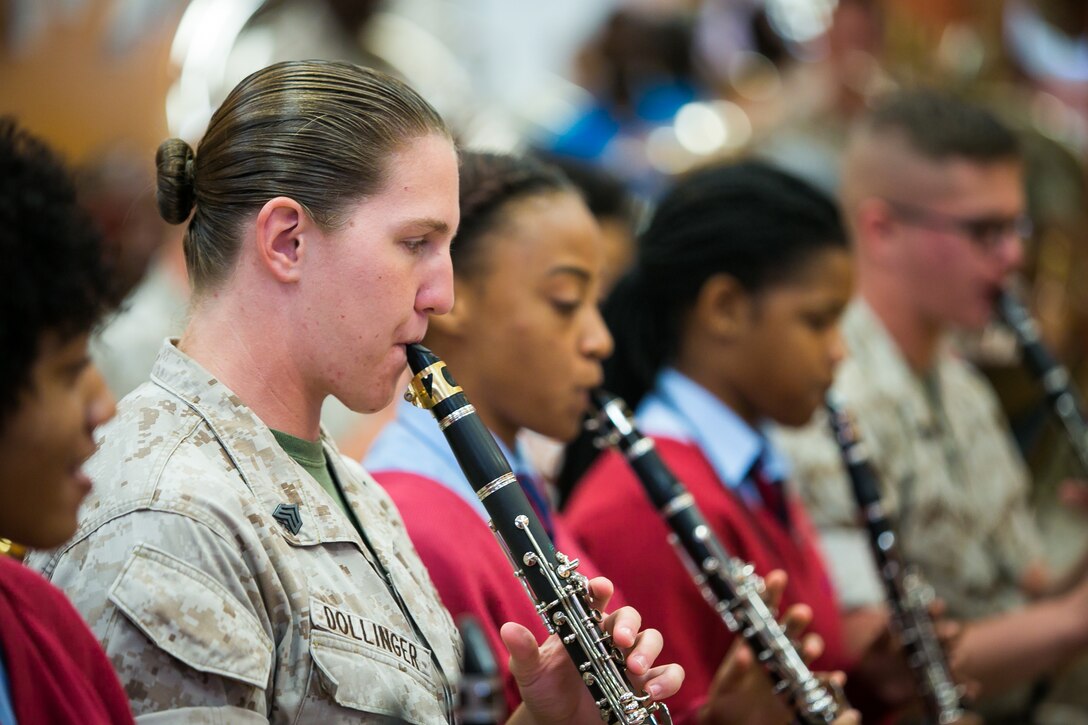Sgt. Elizabeth Dollinger performs alongside students at the Cedar Bridge Academy in Bermuda. 2nd MAW band visited the school to share musical knowledge with the younger students, prior to their performance at the Bermuda 50th Regiment Tattoo, 22-24 October. The Bermuda Tattoo presented a world-class spectacle of music and military precision at the historic grounds of the Keep Yard, Royal Naval Dockyard. Performers from the United States, United Kingdom, Canada and the Caribbean joined the Royal Bermuda Regiment Band and Corps of Drums. (Courtesy Photo)
