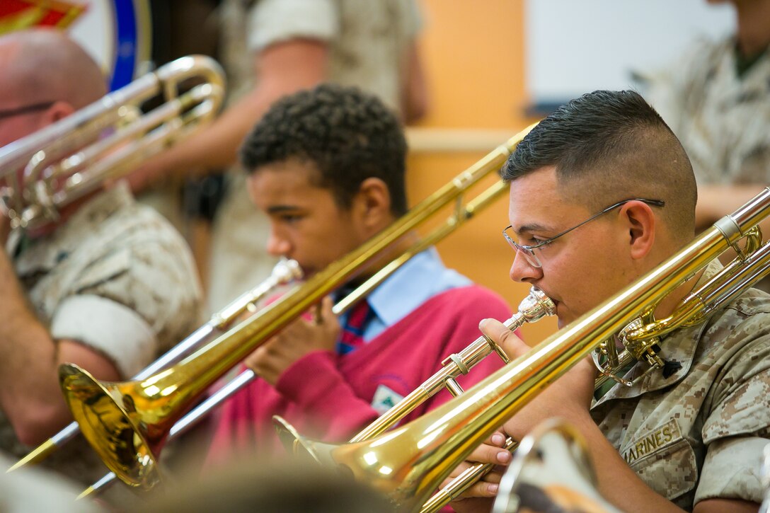 Cpl. Andy Aronstam performs alongside students at the Cedar Bridge Academy in Bermuda. 2nd Marine Aircraft Wing Band visited the school to share musical knowledge with the younger students, prior to their performance at the Bermuda 50th Regiment Tattoo, 22-24 October. The Bermuda Tattoo presented a world-class spectacle of music and military precision at the historic grounds of the Keep Yard, Royal Naval Dockyard. Performers from the United States, United Kingdom, Canada and the Caribbean joined the Royal Bermuda Regiment Band and Corps of Drums. (Courtesy Photo)