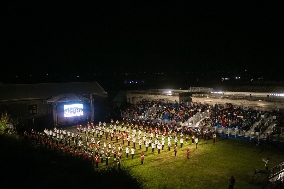 2nd Marine Aircraft Wing Band performs alongside other units during a mass performance at the Bermuda 50th Regiment Tattoo, 22-24 October. The Bermuda Tattoo presented a world-class spectacle of music and military precision at the historic grounds of the Keep Yard, Royal Naval Dockyard. Performers from the United States, United Kingdom, Canada and the Caribbean joined the Royal Bermuda Regiment Band and Corps of Drums. (Courtesy Photo)
