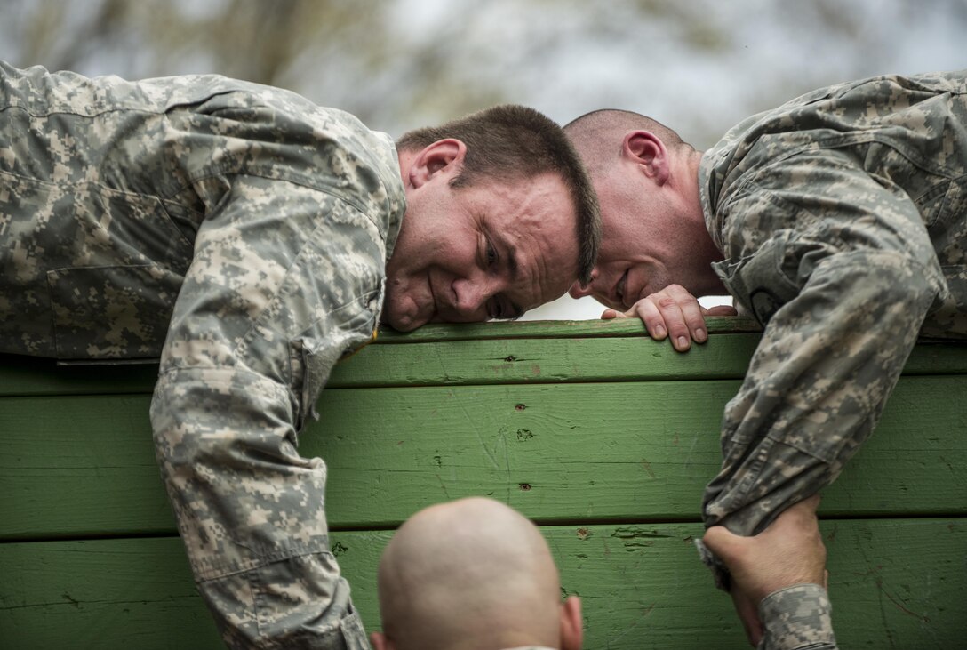 Sgt. Lloyd Russell, of Fredericktown, Mo., and Sgt. Ian Flanagan, of Carthage, Ind., U.S. Army Reserve military police Soldiers, try to pull a teammate up to a wall during a Leadership Reaction Course at Camp Atterbury, Ind., Nov. 5, during a three-day range training event hosted and organized by the 384th Military Police Battalion, headquartered at Fort Wayne, Ind. The field training involving more than 550 U.S. Army Reserve Soldiers and included ranges using eight different weapons systems, plus combat patrolling and a rifle marskmanship competition. (U.S. Army photo by Master Sgt. Michel Sauret)