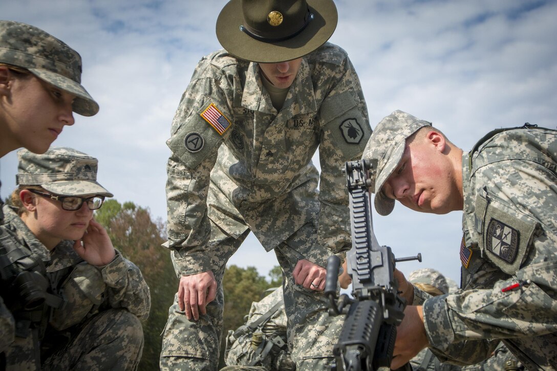 Army Sgt. Steven Stowe, center, teaches a group of Clemson University Reserve Officer Training Corps cadets how to disassemble an M249 machine gun during a leadership exercise in Clemson, S.C., Oct. 24, 2015. Stowe is an Army Reserve drill sergeant assigned to the 98th Training Division's Company D, 1st Battalion, 518th Infantry Regiment, 2nd Brigade Combat Team. U.S. Army photo by Sgt. Ken Scar