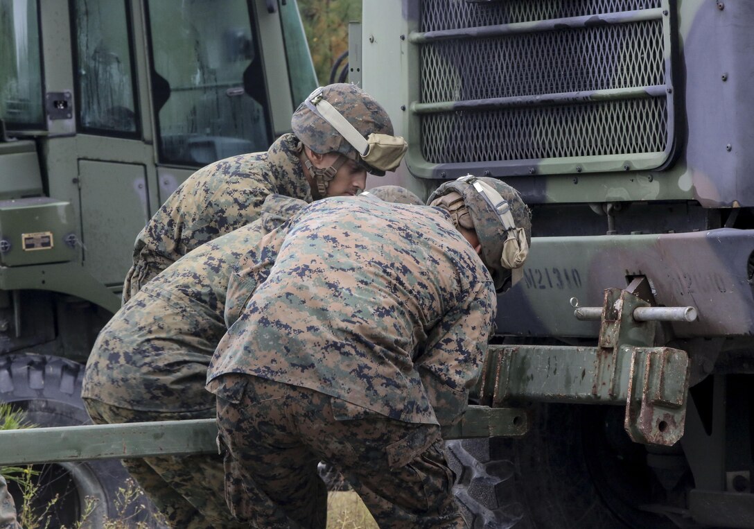 Marine students in the 8th Engineer Support Battalion Bridge Master’s Course rig a bridge piece to a seven-ton vehicle during a field exercise at Camp Lejeune, N.C., Nov. 4, 2015. The course teaches Marines to lead the bridge building process, and is hosting Marines from 9th Engineer Support Battalion, 3rd Marine Logistics Group, based in Camp Hansen, Okinawa. Marines used the seven-ton vehicle to push or pull the entire bridge as needed. (U.S. Marine Corps photo by Cpl. Paul S. Martinez/Released)