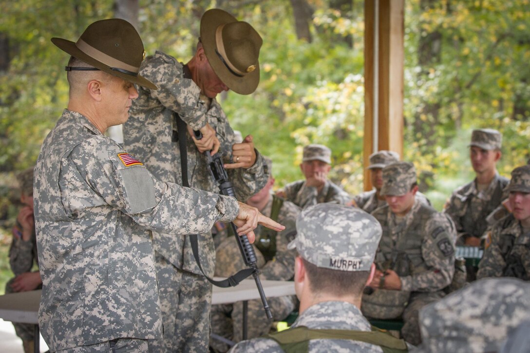 Army Staff Sgt. Hal Martin, left, and Sgt. 1st Class Walter Snow teach preliminary marksmanship to a group of Clemson University Reserve Officer Training Corps cadets during a leadership exercise in Clemson, S.C., Oct. 24, 2015. Martin and Snow are Army Reserve drill sergeants assigned to the 98th Training Division's Company D, 1st Battalion, 518th Infantry Regiment, 2nd Brigade Combat Team. U.S. Army photo by Sgt. Ken Scar