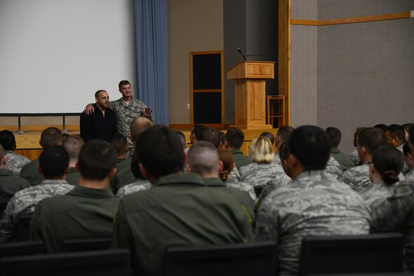 Col. Thomas Shank, 47th Flying Training Wing commander, and guest speaker Kevin Hines; global speaker, author and mental health advocate, address the crowd as part of Wingman Day in Anderson Hall on Laughlin Air Force Base, Texas, Nov. 5, 2015. Laughlin members also took part in a wing photo and attended the wing picnic; which involved demonstrations from various Del Rio organizations. (U.S. Air Force photo by Airman 1st Class Brandon May)