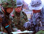 Army Sgt. 1st Class Brian Gustin of the Missouri Army National Guard's 1st Battalion, 138th Infantry Regiment, explains a route reconnaissance map to two soldiers with the Japanese Ground Self-Defense Force, 26th Infantry Regiment Nov. 3, 2010. Gustin was one of about 200 soldiers with the Missouri Army National Guard that trained with the Japanese military as part of Orient Shield 11 in northern Japan.