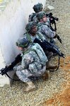 Georgia National Guard soldiers stack behind a wall during training at the Joint Multinational Readiness Center in Hohenfels, Germany, Nov. 9, 2011. National Guard Soldiers are part of the KFOR 15 rotation preparing to deploy to Kosovo in upcoming months. National Guard units for the December rotation are coming from multiple states and one territory: Wisconsin, Mississippi, Georgia, Nebraska, Vermont, North Dakota, New Jersey, Wyoming, Massachusetts and Puerto Rico.