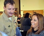 Navy Petty Officer 1st Class Jeff Leslie, who deployed to Iraq in 2009, and his wife Shannon, interact with employers during the "Hiring Our Heroes" job fair in Oregon City, Ore., Nov. 19, 2011. The job fair was sponsored by the U.S. Chamber of Commerce and featured a partnership between the Oregon National Guard and Navy Region Northwest Reserve Component Command which was established to better help service members, veterans and families in the region link with reintegration resources.