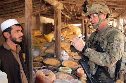 Air National Guard Master Sgt. Greg Dunlap, an agribusiness specialist with the Missouri National Guard Agribusiness Development Team, interviews a shop owner Nov. 17, 2011, in the Kama district of the Afghanistan province of Nangarhar to obtain information on various aspects of the economic situation facing the countries farmers.