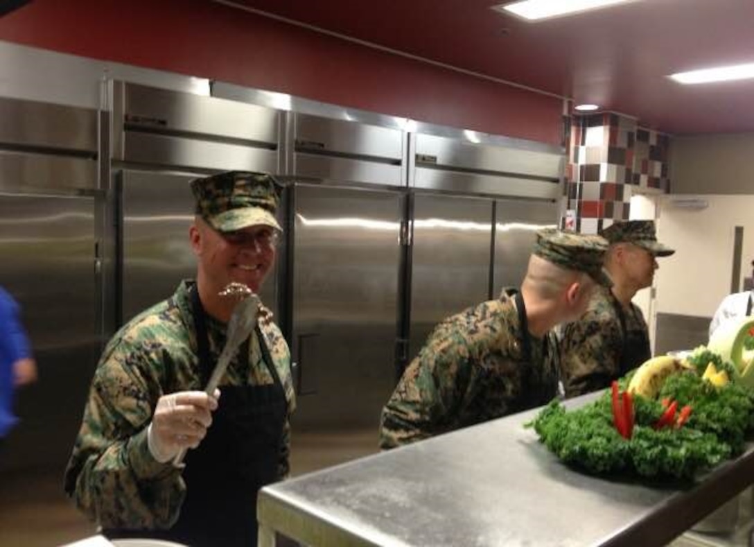 On November 6, 2015 Colonel Scott A. Baldwin, Commanding Officer of Marine Corps Engineer School (MCES), along with officers and senior Staff Non-Commissioned Officers (SNCOs) from MCES assist Sodexo employees in serving the Marine Corps' birthday meal at Courthouse Bay, Camp Lejeune, N.C.
