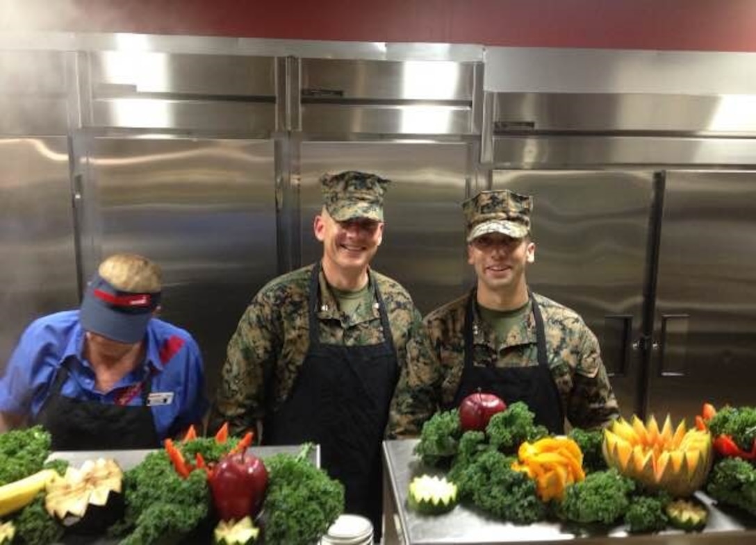 On November 6, 2015 Lieutenant Colonel Taylor P. White and Captain Zack A. Pinkerton, officers with Marine Corps Engineer School (MCES), assist Sodexo employees in serving the Marine Corps' birthday meal at Courthouse Bay, Camp Lejeune, N.C.
