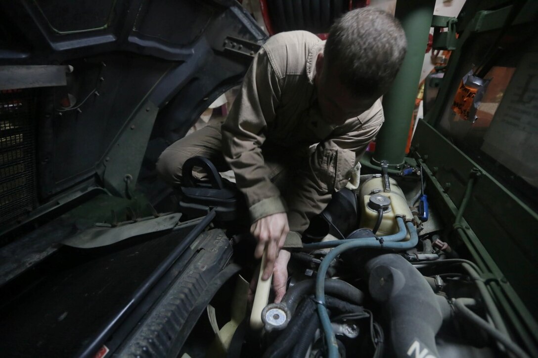 INDIAN OCEAN (Nov. 5, 2015) U.S. Marine Cpl. Cody Stevens cleans the belt pulleys on a Humvee aboard the USS Anchorage (LPD 23). Stevens is a light armored vehicle mechanic with 1st Radio Battalion Detachment, 15th Marine Expeditionary Unit. The 15th MEU is currently deployed in the Indo-Asia-Pacific region to promote regional stability and security in the U.S. 7th Fleet area of operations. (U.S. Marine Corps photo by Sgt. Jamean Berry/Released)