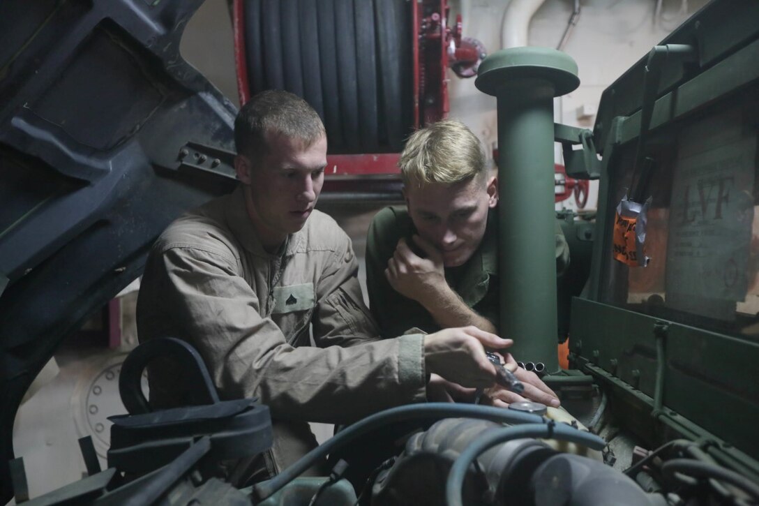 INDIAN OCEAN (Nov. 5, 2015) U.S. Marine Sgt. Carl Provost, right, supervises as Cpl. Cody Stevens removes bolts from a Humvee aboard the USS Anchorage (LPD 23). Stevens is a light armored vehicle mechanic with 1st Radio Battalion Detachment, 15th Marine Expeditionary Unit, and Provost is a maintenance chief with the 15th MEU. The 15th MEU is currently deployed in the Indo-Asia-Pacific region to promote regional stability and security in the U.S. 7th Fleet area of operations. (U.S. Marine Corps photo by Sgt. Jamean Berry/Released)