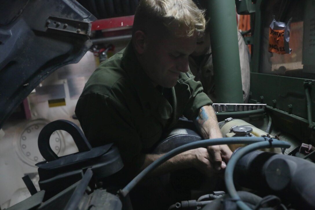 INDIAN OCEAN (Nov. 5, 2015) U.S. Marine Sgt. Carl Provost conducts maintenance on a Humvee aboard the USS Anchorage (LPD 23). Provost is a maintenance chief with the 15th Marine Expeditionary Unit. The 15th MEU is currently deployed in the Indo-Asia-Pacific region to promote regional stability and security in the U.S. 7th Fleet area of operations. (U.S. Marine Corps photo by Sgt. Jamean Berry/Released)