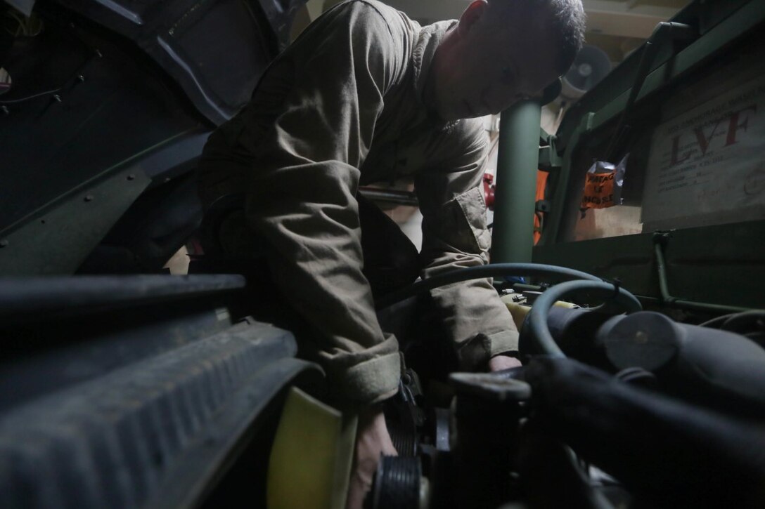 INDIAN OCEAN (Nov. 5, 2015) U.S. Marine Cpl. Cody Stevens performs maintenance on a Humvee aboard the USS Anchorage (LPD 23). Stevens is a light armored vehicle mechanic with 1st Radio Battalion Detachment, 15th Marine Expeditionary Unit. The 15th MEU is currently deployed in the Indo-Asia-Pacific region to promote regional stability and security in the U.S. 7th Fleet area of operations. (U.S. Marine Corps photo by Sgt. Jamean Berry/Released)