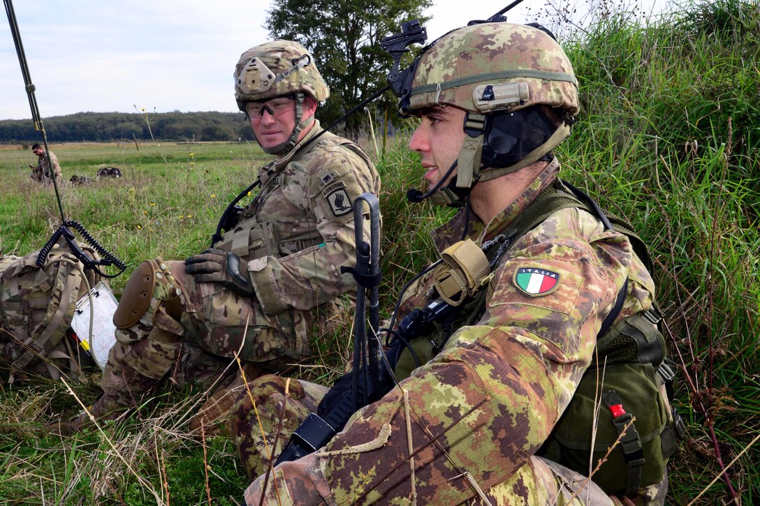 A U.S. paratrooper, left, and an Italian soldier participate during a combined air assault and seizure mission on Lidia drop zone during exercise Mangusta 15 in Siena, Italy, Oct. 26, 2015. U.S. Army photo by Elena Baladelli
