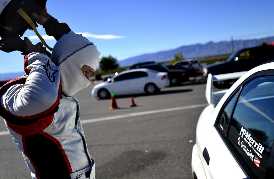 Tech. Sgt. Gabriel, a 432nd Wing/432nd Air Expeditionary Wing MQ-9 Reaper sensor operator, takes his helmet off after racing at the Spring Mountain Raceway Nov. 1, 2015, in Pahrump, Nevada. Gabriel participated in the race as part of the Redline Time Attack series which puts races in different class against the clock to see who can get the fastest time. Gabriel placed second in second highest class. (U.S. Air Force photo/Airman 1st Class Christian Clausen) 