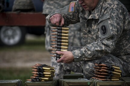 A U.S. Army Reserve Soldier with the 1st Battalion, 330th Infantry Regiment, of the 95th Infantry Division, prepares clips of .50-caliber rounds for an M2 Browning familiarization range at Camp Atterbury, Ind., Nov. 5. The 384th Military Police Battalion, headquartered at Fort Wayne, Ind., organized a three-day range and field training exercise involving more than 550 U.S. Army Reserve Soldiers and incorporated eight different weapons systems, plus combat patrolling and a rifle marksmanship competition at Camp Atterbury, Ind., Nov. 5-7. (U.S. Army photo by Master Sgt. Michel Sauret)