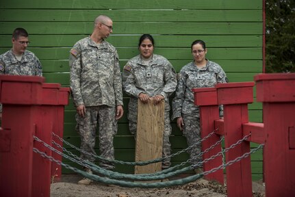 U.S. Army Reserve military police Soldiers pause to strategize their next move during a Leadership Reaction Course as part of a team-building exercise at Camp Atterbury, Ind., Nov. 5, during a three-day range training event hosted and organized by the 384th Military Police Battalion, headquartered at Fort Wayne, Ind. The field training involving more than 550 U.S. Army Reserve Soldiers and included ranges using eight different weapons systems, plus combat patrolling and a rifle marskmanship competition. (U.S. Army photo by Master Sgt. Michel Sauret)