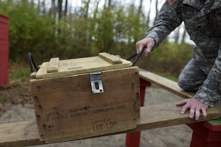 A U.S. Army Reserve military police Soldier pulls a box along a suspended board as his team tries to navigate through a Leadership Reaction Course as part of a team-building exercise at Camp Atterbury, Ind., Nov. 5, during a three-day range training event hosted and organized by the 384th Military Police Battalion, headquartered at Fort Wayne, Ind. The field training involving more than 550 U.S. Army Reserve Soldiers and included ranges using eight different weapons systems, plus combat patrolling and a rifle marskmanship competition. (U.S. Army photo by Master Sgt. Michel Sauret)