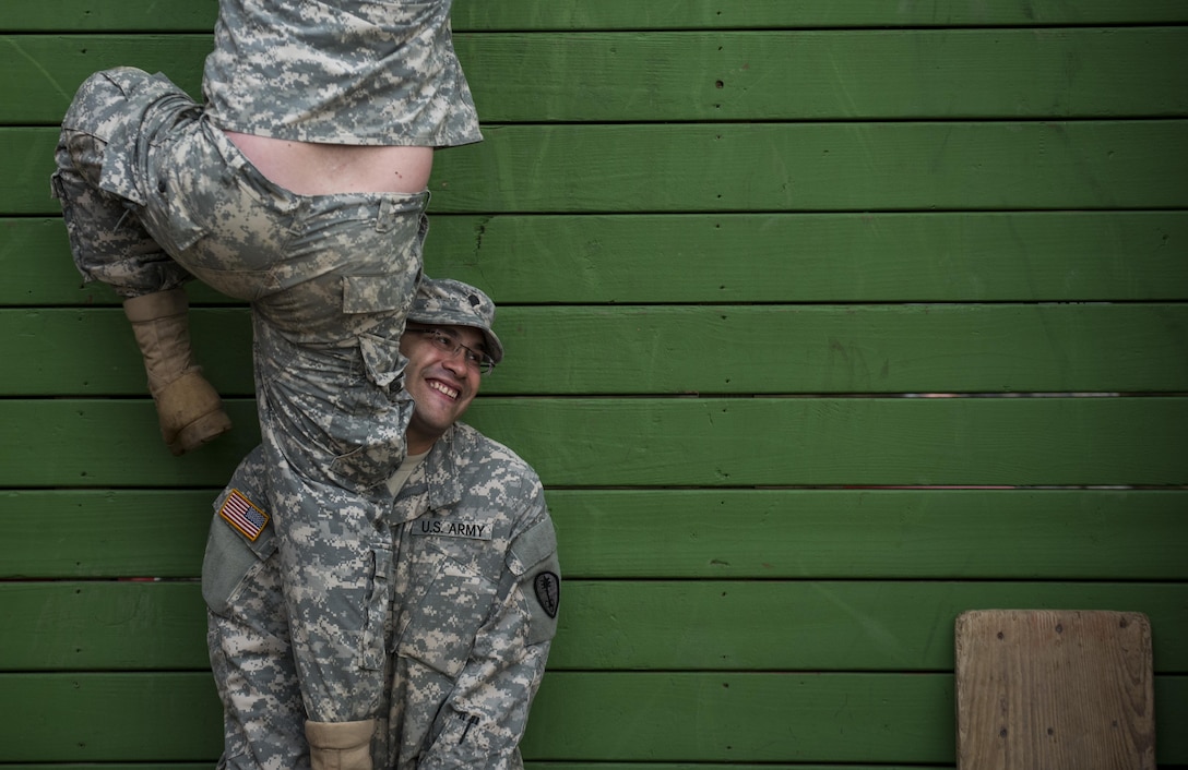 Spc. Josue Centeno, a U.S. Army Reserve Soldier with the 354th Military Police Company, of St. Louis, Mo., lifts a Soldier up a wall as they navigate through a Leadership Reaction Course as part of a team-building exercise at Camp Atterbury, Ind., Nov. 5, during a three-day range training event hosted and organized by the 384th Military Police Battalion, headquartered at Fort Wayne, Ind. The field training involving more than 550 U.S. Army Reserve Soldiers and included ranges using eight different weapons systems, plus combat patrolling and a rifle marskmanship competition. (U.S. Army photo by Master Sgt. Michel Sauret)