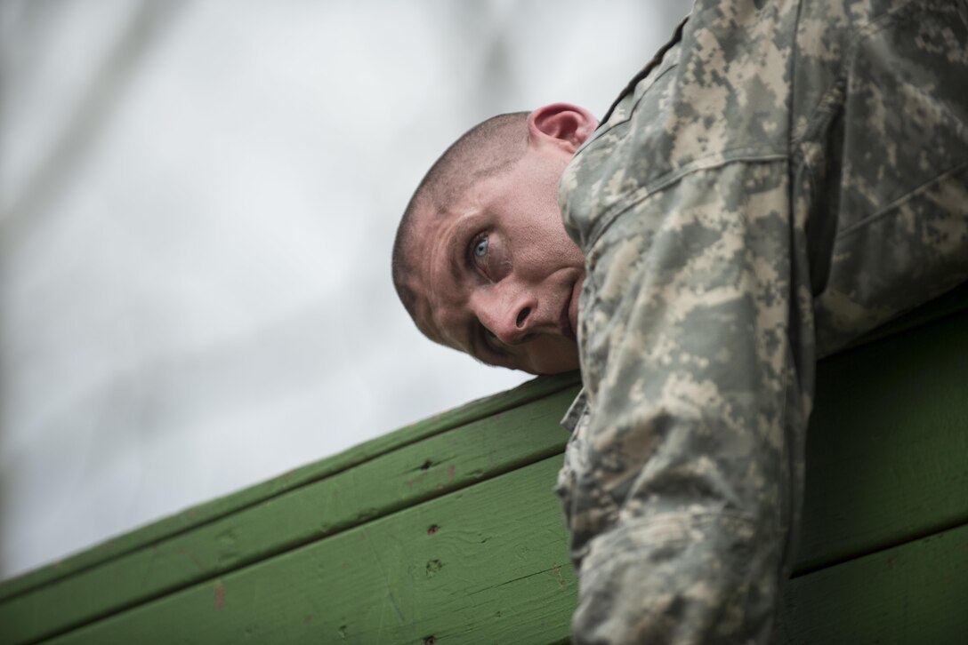 Sgt. Ian Flanagan, of Carthage, Ind., a U.S. Army Reserve military police Soldier with the 384th Military Police Battalion, waits on a wall for a teammate to jump up during a Leadership Reaction Course at Camp Atterbury, Ind., Nov. 5, as part of a three-day range training event hosted and organized by the 384th Military Police Battalion, headquartered at Fort Wayne, Ind. The field training involving more than 550 U.S. Army Reserve Soldiers and included ranges using eight different weapons systems, plus combat patrolling and a rifle marskmanship competition. (U.S. Army photo by Master Sgt. Michel Sauret)