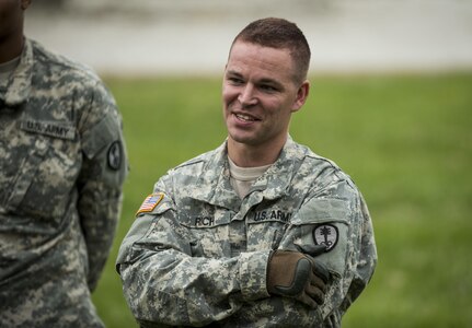 A U.S. Army Reserve military police Soldier jokes with fellow Soldiers during a Leadership Reaction Course as part of a team-building exercise at Camp Atterbury, Ind., Nov. 5, during a three-day range training event hosted and organized by the 384th Military Police Battalion, headquartered at Fort Wayne, Ind. The field training involving more than 550 U.S. Army Reserve Soldiers and included ranges using eight different weapons systems, plus combat patrolling and a rifle marskmanship competition. (U.S. Army photo by Master Sgt. Michel Sauret)