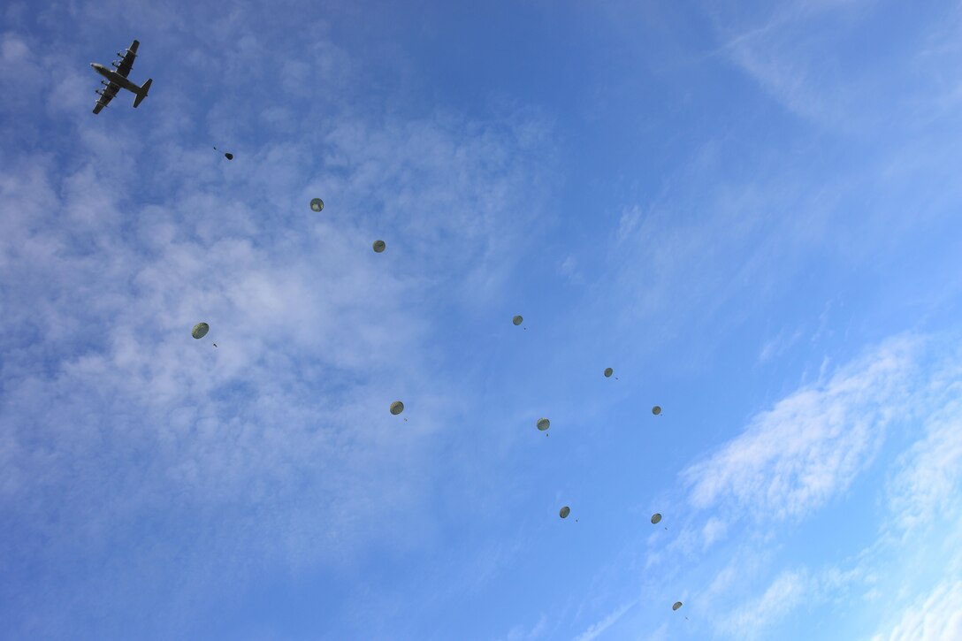 U.S. paratroopers and Italian soldiers conduct an airborne operation from a C-130 aircraft during a combined air assault and seizure mission over Lidia drop zone during exercise Mangusta 15 in Siena, Italy, Oct. 26, 2015. U.S. Army photo by Elena Baladelli