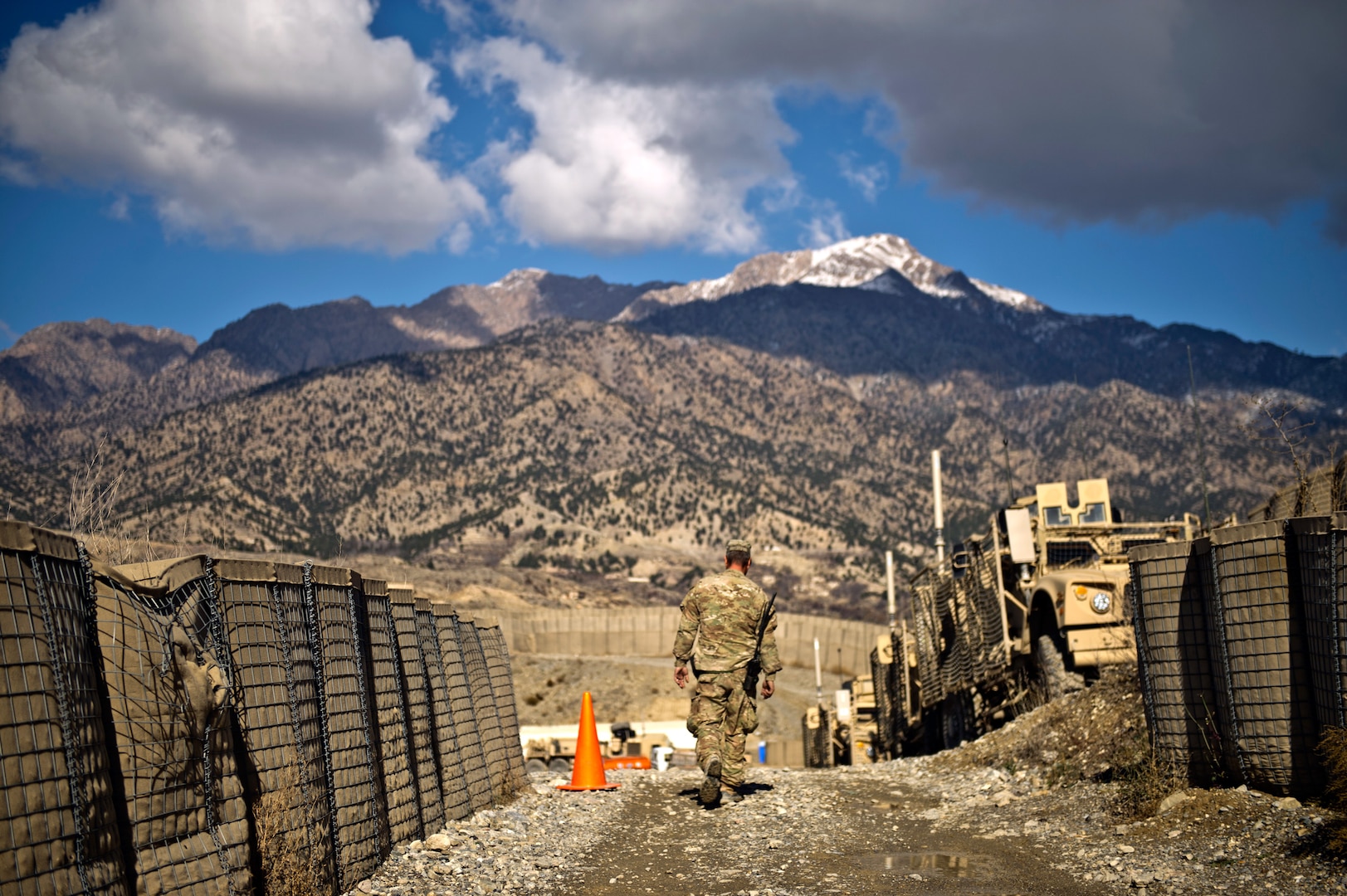 U.S. Army Sgt. Barry Dilley, a supply noncommissioned officer with the Oklahoma Army National Guard's 1st Battalion, 279th Infantry, walks down a path at Combat Out Post Herrera Nov. 28, 2011. The COP, which sits 8,700 feet above sea level and is surrounded by mountains and local villagers, received a Joint Precision Airdrop System resupply Nov. 27, 2011, consisting of 18,000 lbs of fuel. COP Herrera's local terrain, coupled with the high Taliban presence, makes it difficult for ground resupply missions.