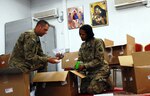 Chaplain's assistant Army Staff Sgt. Shawn Bartz, from the Virginia Army National Guard 116th Infantry Brigade Combat Team, and Army Spc. Brehann Hudgins open and inventory care packages at Forward Operating Base Lagman, Afghanistan. The "Stonewall Brigade" is deployed to Zabul province conducting counterinsurgency operations in support of Operation Enduring Freedom.