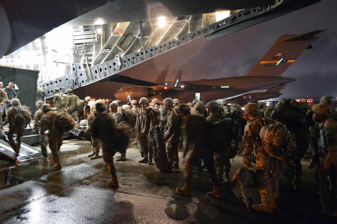 Army paratroopers load onto an Air Force C-17 Globemaster III aircraft during Exercise Ultimate Reach on Pope Army Airfield, N.C., Nov. 3, 2015. The U.S. Transportation Command tests the ability of the 18th Air Force to plan and conduct strategic airdrop missions. The paratroopers are with the 82nd Airborne Division’s 2nd Brigade Combat Team. U.S. Air Force photo by Marvin Krause