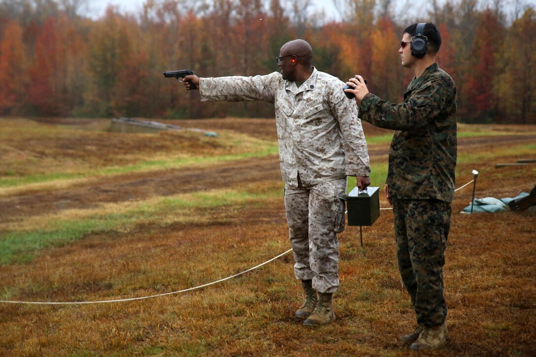 A Marine fires an M9 Beretta while carrying an ammo can during the Quantico Shooting Team's 2015 Combat Shooting Match on Marine Corps Base Quantico, V a., Oct. 28, 2015. Marines from along the East Coast were required to plan, think and react quickly with several different weapons in six stages. U.S. Marine Corps photo by Cpl. Kathy Nunez