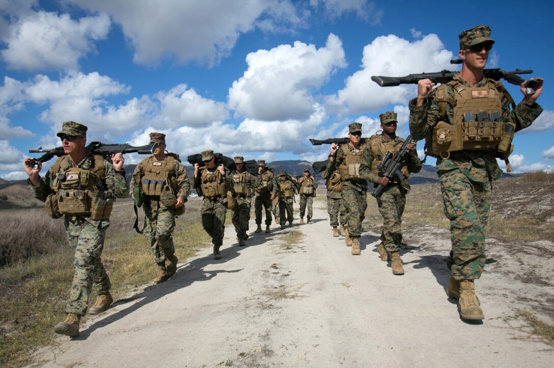 Marines carry M240B machine guns and M249 light machine guns from a firing range after weapons training on Camp Pendleton, Calif., Nov. 3, 2015.The training develops efficiency with the two types of  machine guns and reinforces combat readiness. The Marines are assigned to the 11th Marine Expeditionary Unit. U.S. Marine Corps photo by Cpl. Xzavior T. McNeal