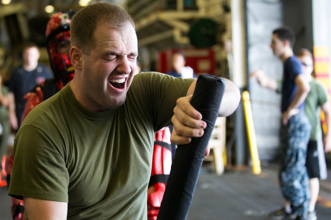 U.S. Marine Sgt. Benjamin Stewart practices baton techniques after being sprayed with oleoresin capsicum during a nonlethal weapons course on the amphibious assault ship USS Essex in the Indian Ocean, Oct. 31, 2015. U.S. Marines and sailors were sprayed across the face with the chemical spray and went through a series of exercises during the course. Stewart is an intelligence specialist with Combat Logistics Battalion 15, 15th Marine Expeditionary Unit. U.S. Marine Corps photo by Sgt. Anna Albrecht
