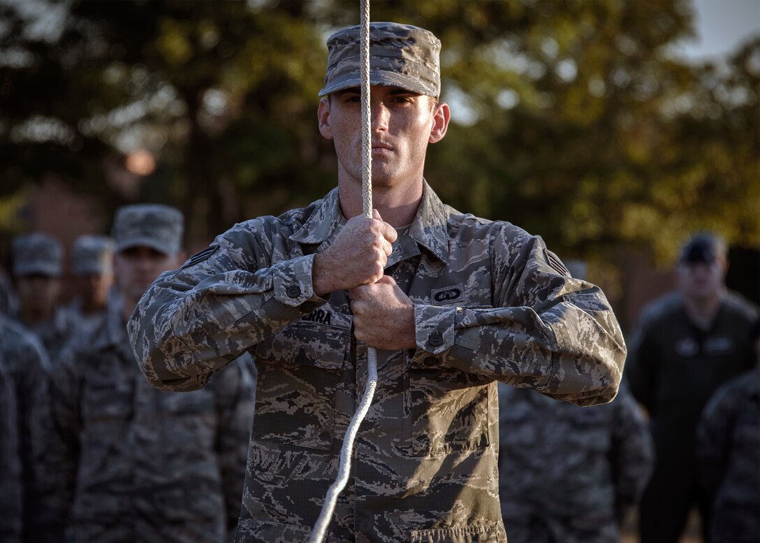 Senior Airman Joshua Becerra, a 71st Operations Support Squadron Airman, holds a line during a retreat ceremony at Vance Air Force Base, Oklahoma, Nov. 3. Becerra and fellow Airman Leadership School students here performed a retreat ceremony as part of the ALS professional Airmanship curriculum. (U.S. Air Force photo / David Poe)