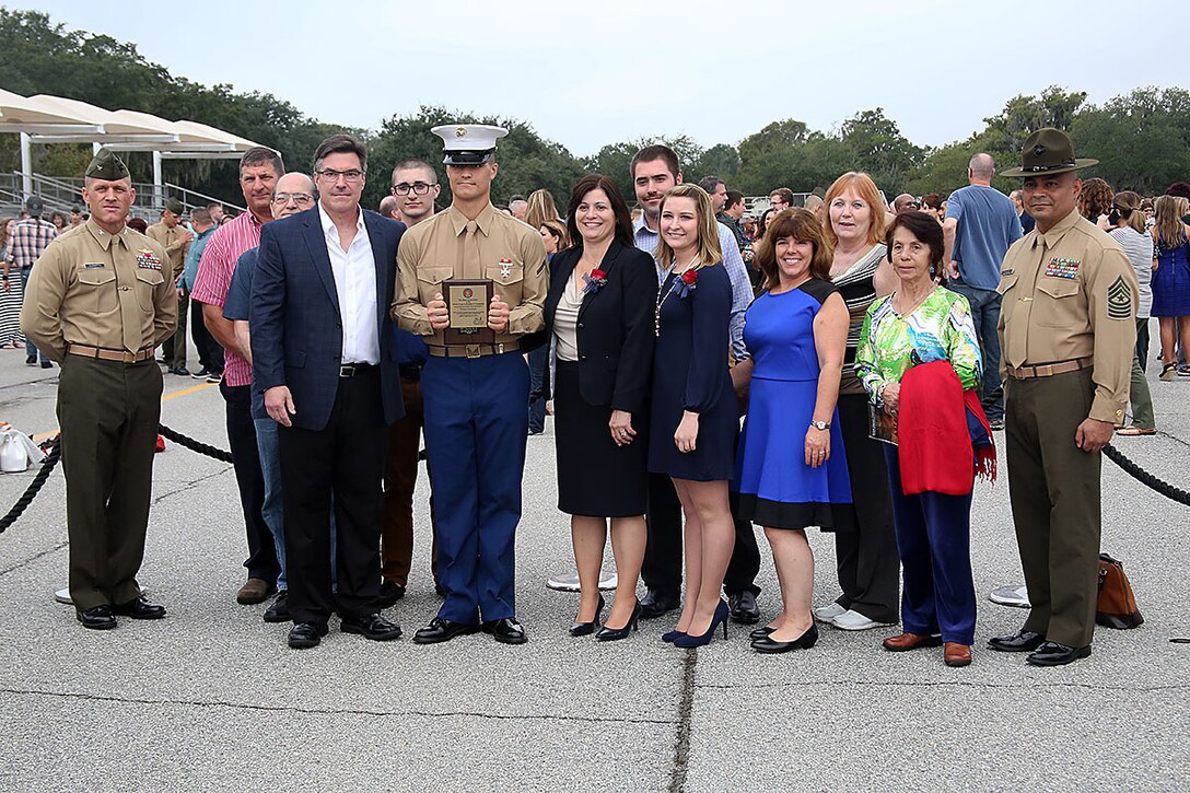 Pfc. Kevin P. Harris, honor graduate of platoon 3082, stands with his family, Col. Paul D. Cucinotta and Sgt. Maj. Nicholas A. Deabreu after recruit graduation Nov. 6, 2015 at Marine Corps Recruit Depot Parris Island, S.C. Harris, a native of New Port Richey, Fla., was recruited by Staff Sgt. Frederick G. Kern at Recruiting Substation Port Richey, Recruiting Station Orlando. To be recommended as an honor graduate, a recruit must not only display honor, courage, and commitment during their three months of training but excel in physical training, knowledge, and have a team player disposition. (Official Marine Corps photo by Cpl. John-Paul Imbody)