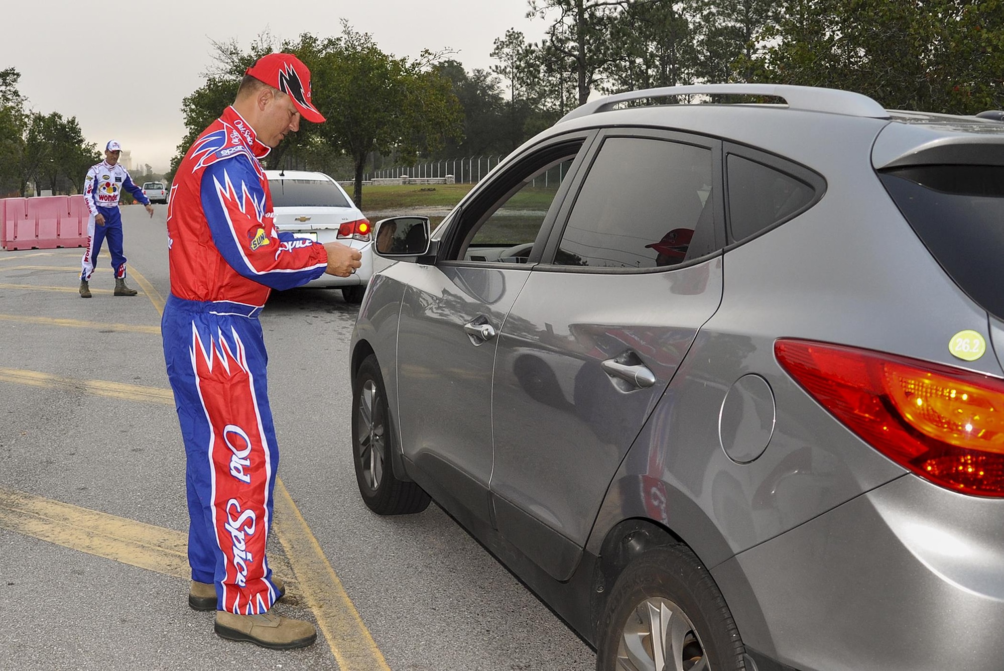 Chief Master Sgt. Brian Bischoff, 919th Special Operations Wing command chief, dresses as “Cal Naughton Jr.” from “Talladega Nights” to greet wing members at the gate at the beginning of the unit training assembly Nov. 6 at Duke Field.  The wing’s vice commander (pictured in white) joined the chief dressed as “Ricky Bobby.”  (U.S. Air Force photo/Dan Neely)